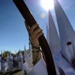 A penitent with a rosary on his hand parades during the San Gonzalo brotherhood procession in Seville on March 30th, 2015. Penitents wear the traditional capirote or tall, conical hat which used to be worn by people doing penance as they paraded through town, so locals could not tell who was the sinner behind the hood. Photo: Cristina Quicler/AFP