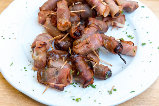 Spanish bacon-wrapped dates, Expect a sweet and savoury flavour burst with this Spanish dish. Photo: Marco Verch/Flickr