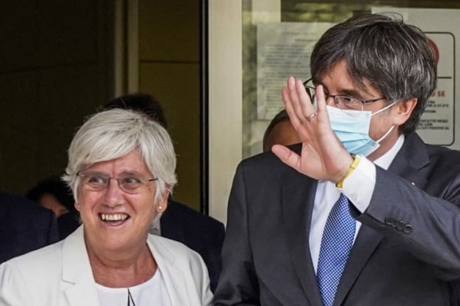 Catalonia's exiled former leader Carles Puigdemont (R), escorted by Catalan economist and member of the European Parliament, Clara Ponsati