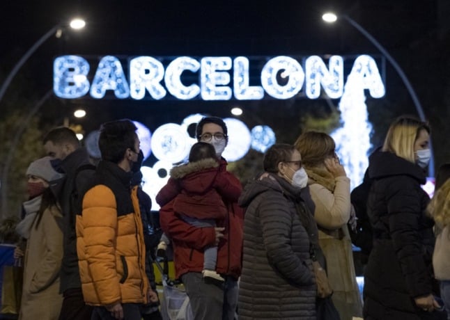Families walk past the Christmas in Barcelona in 2020