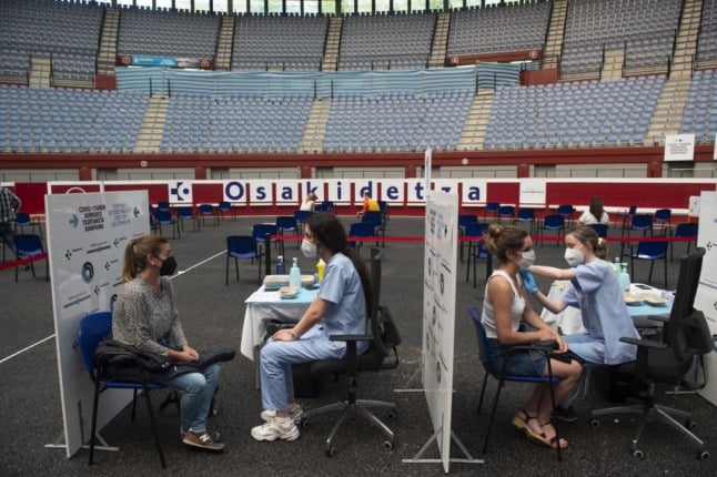 Health workers vaccinate people against Covid-19 at the Donostia Arena former bullring in San Sebastian on May 31, 2021. (Photo by ANDER GILLENEA / AFP)