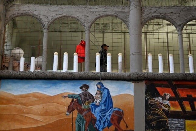 Religious murals on a walls of Justo's cathedral. (Photo by Gabriel BOUYS / AFP)