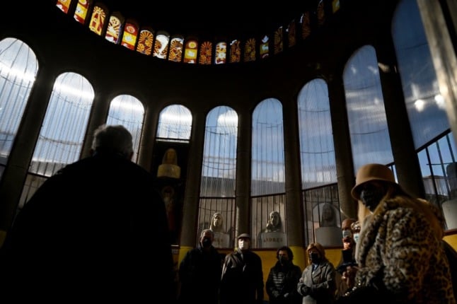 Visit gaze at the stained glass and busts in of the cathedral's completed sections. (Photo by Gabriel BOUYS / AFP)