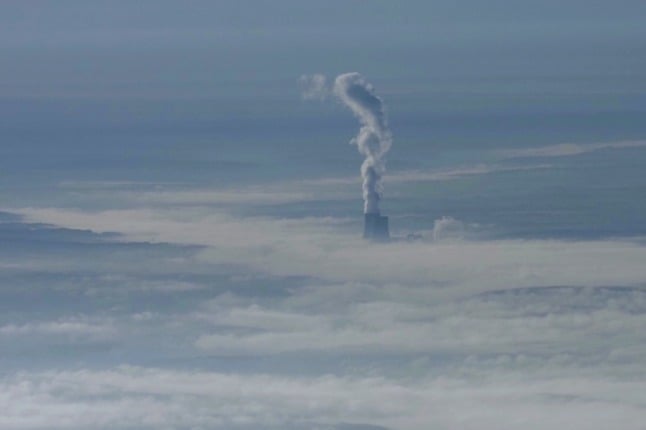 The cooling towers of Civaux nuclear plant are seen over the clouds